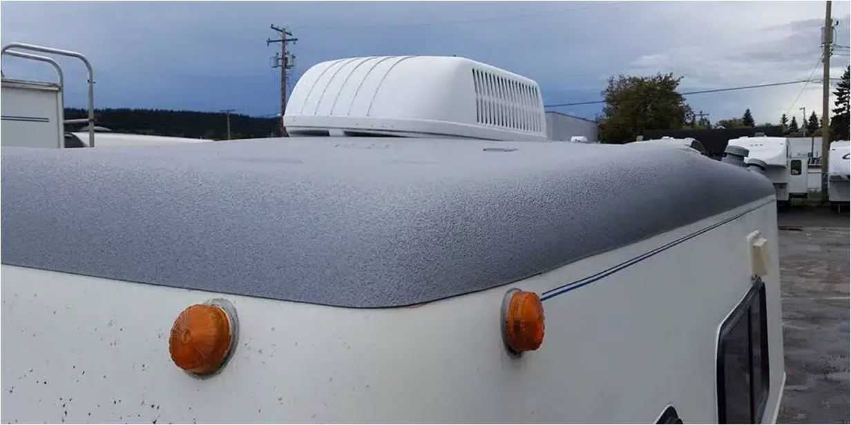 Close-up of Class A Diesel Pusher RV roof edge after coating